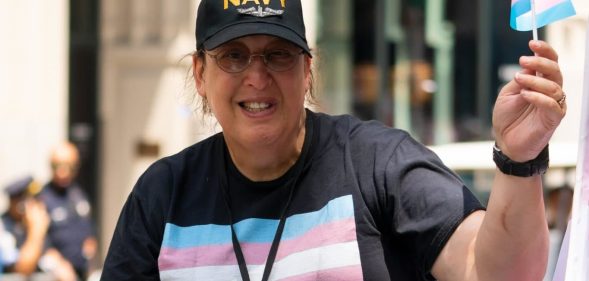 Monica Helms flying a tiny trans Pride flag and wearing a t-shirt with it emblazoned on