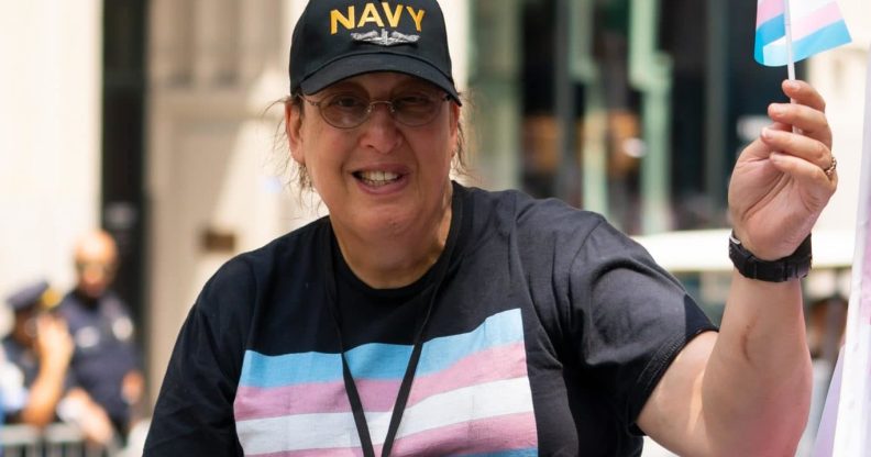 Monica Helms flying a tiny trans Pride flag and wearing a t-shirt with it emblazoned on