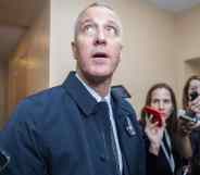 Sean Patrick Maloney looks upwards as he speaks to reporters, their arms raised while holding mobile phones