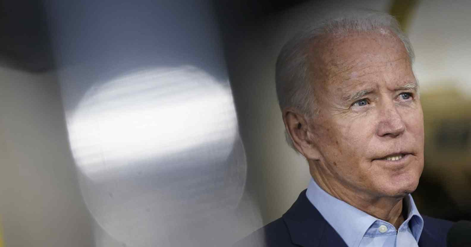Joe Biden in a light blue shirt and dark suit