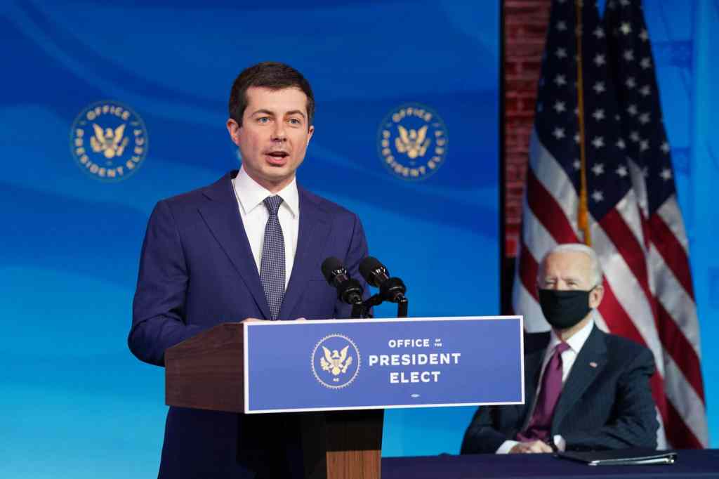 Former Democratic presidential candidate Pete Buttigieg speaks as US President-elect Joe Biden looks on after he was nominated to be Secretary of Transportation