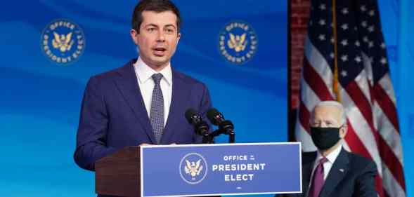 Former Democratic presidential candidate Pete Buttigieg speaks as US President-elect Joe Biden looks on after he was nominated to be Secretary of Transportation