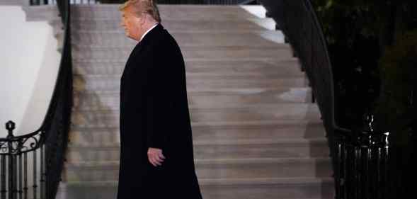 President Donald Trump walks to the White House residence on January 12