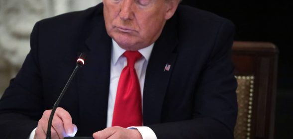 Richard Grenell boss President Donald Trump works on his phone during a roundtable at the State Dining Room of the White House June 18, 2020