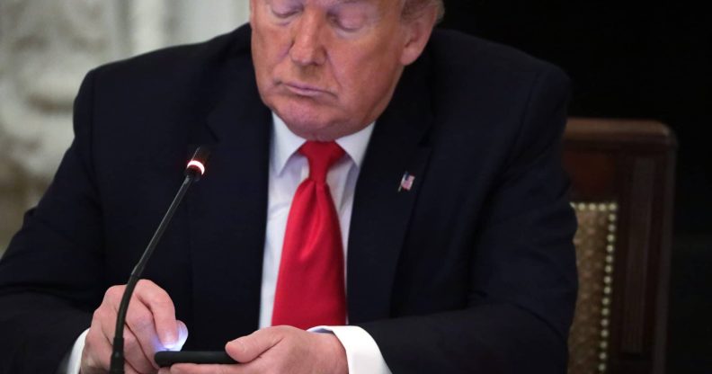 Richard Grenell boss President Donald Trump works on his phone during a roundtable at the State Dining Room of the White House June 18, 2020
