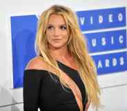 Britney Spears turns to the right in a black dress