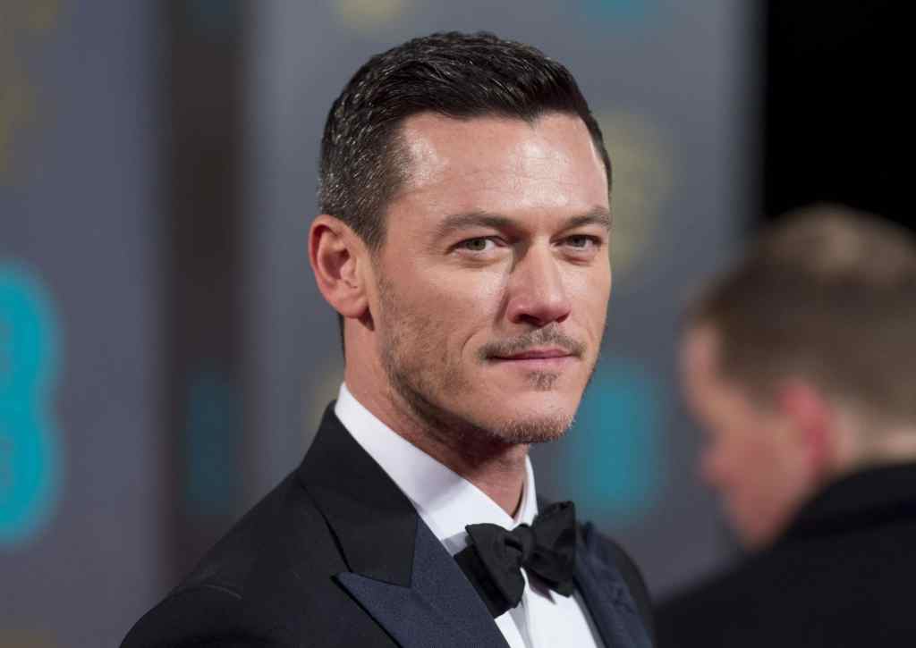 Luke Evans in a tuxedo, looking to his right