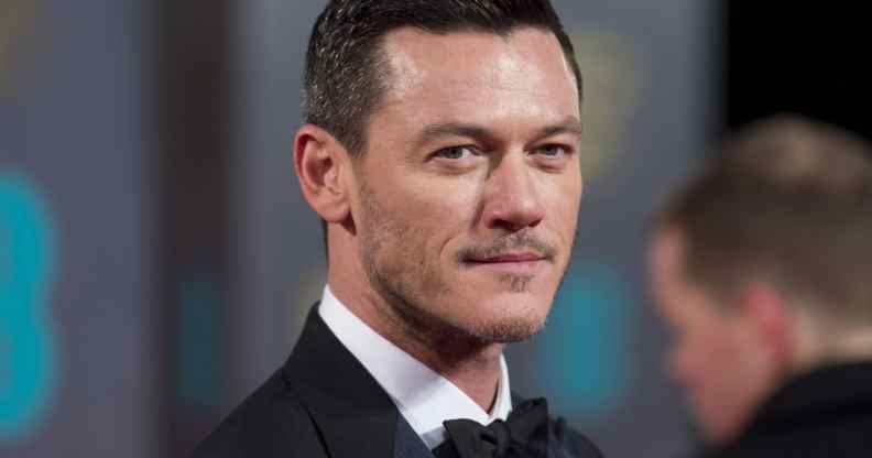 Luke Evans in a tuxedo, looking to his right