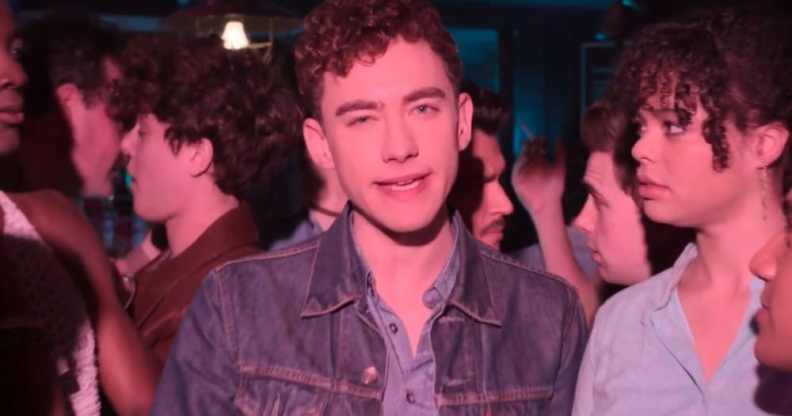 Olly Alexander surrounded by friends in a bar
