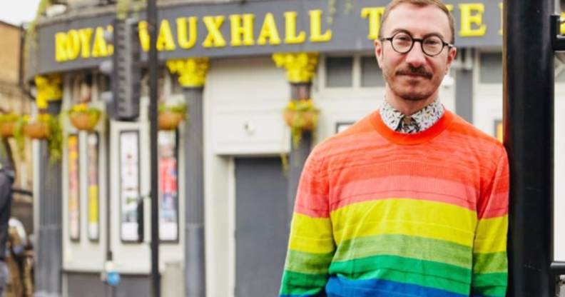 Philip Normal wearing a rainbow jumper standing outside the Royal Vauxhall Tavern
