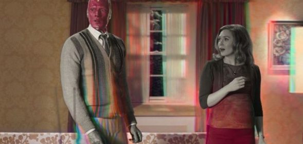 Wanda and Vision in their living room, the scene transforming from black and white to colour