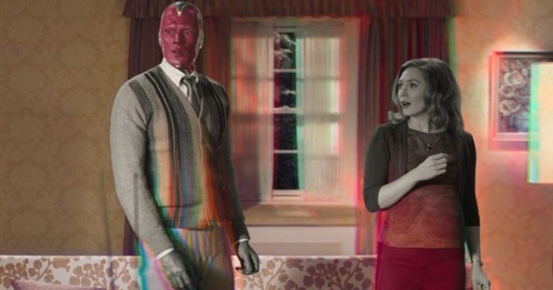 Wanda and Vision in their living room, the scene transforming from black and white to colour