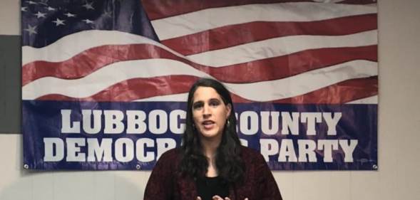 Addison Perry-Franks speaks behind an American flag