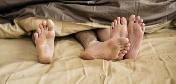 Caucasian couple lying on bed together