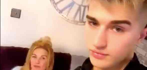 Onlyfans star Camerson Cook poses with his mother, who is sat on a sofa