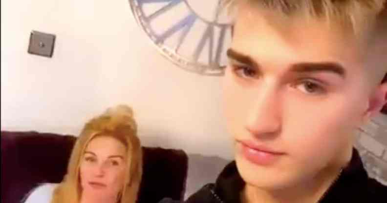 Onlyfans star Camerson Cook poses with his mother, who is sat on a sofa