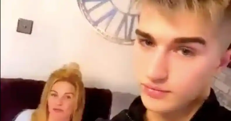 Onlyfans star Camerson Cook poses with his mother, who is sat on a sofa