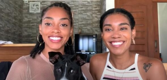 Kristen Gray and Saundra Alexander smile tot he camera with their dog