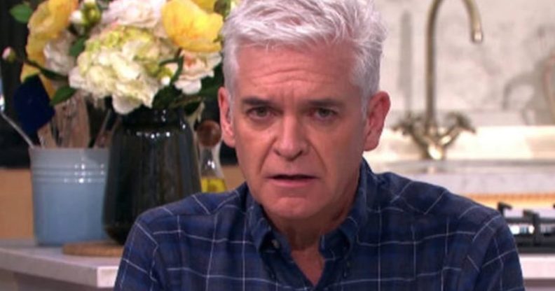 Philip Schofield looks unsettled at the camera while wearing a dark print shirt