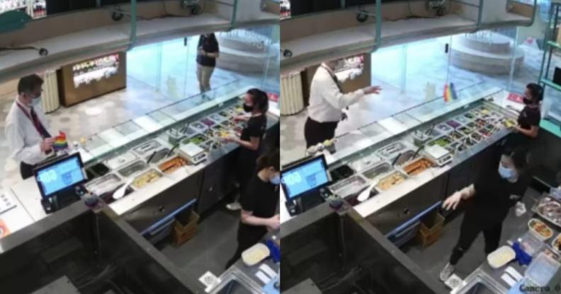 A man in a white shirt and tie grabs and throws an LGBT+ Pride flag at staff behind the counter of a food stall