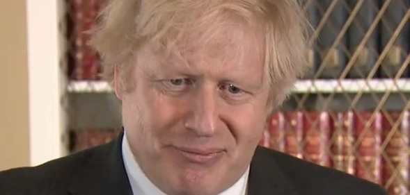Boris Johnson squirms in a suit