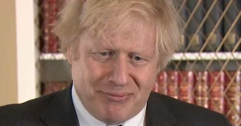 Boris Johnson squirms in a suit
