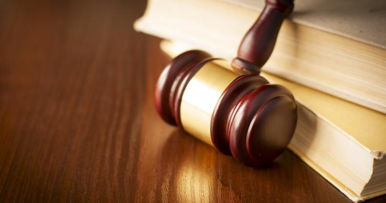 Court gavel leaning against books