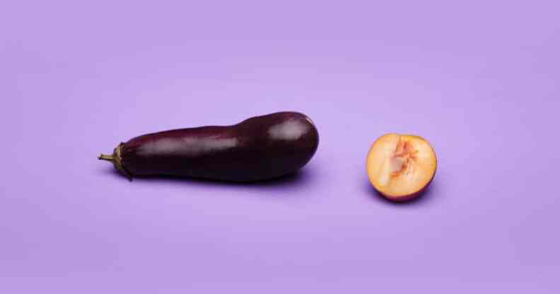 An aubergine and a peach, cut in half, against a purple background