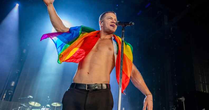 Dan Reynolds of Imagine Dragons holds a gay pride flag