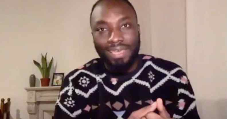 Ignatius Annor speaks in his home wearing a patterned jumper