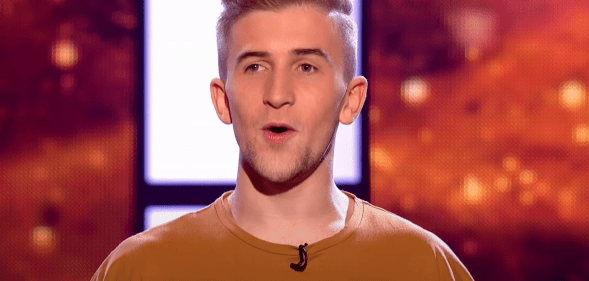 Calum Scott Howells singing on a reality TV show stage