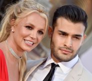 Close crop of Britney Spears and her boyfriend Sam Asghari smiling on the red carpet