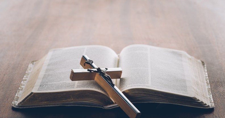 Picture of a bible with a cross lying on it