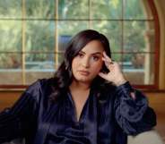 Demi Lovato in the trailer for her documentary, sitting on a chair resting her hand on her face