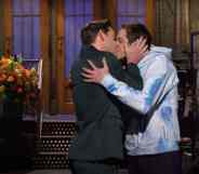 John Krasinski and Pete Davidson share a kiss on the set of Saturday Night Live