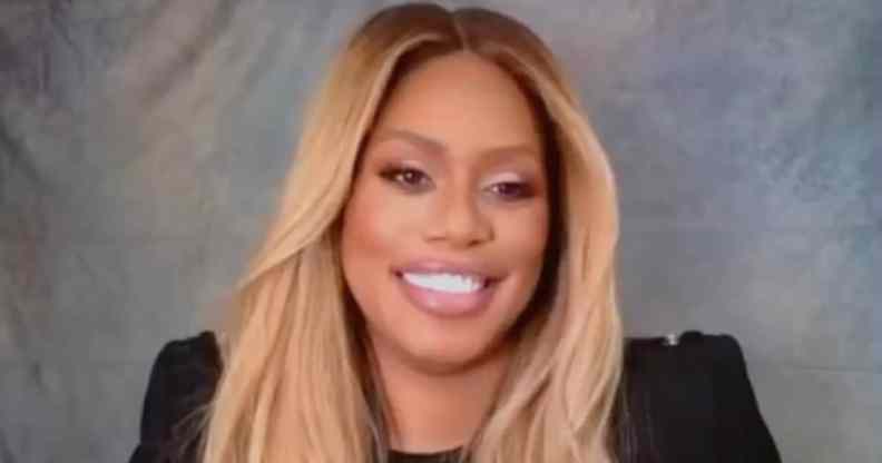 Laverne Cox smiles to the camera in a black top