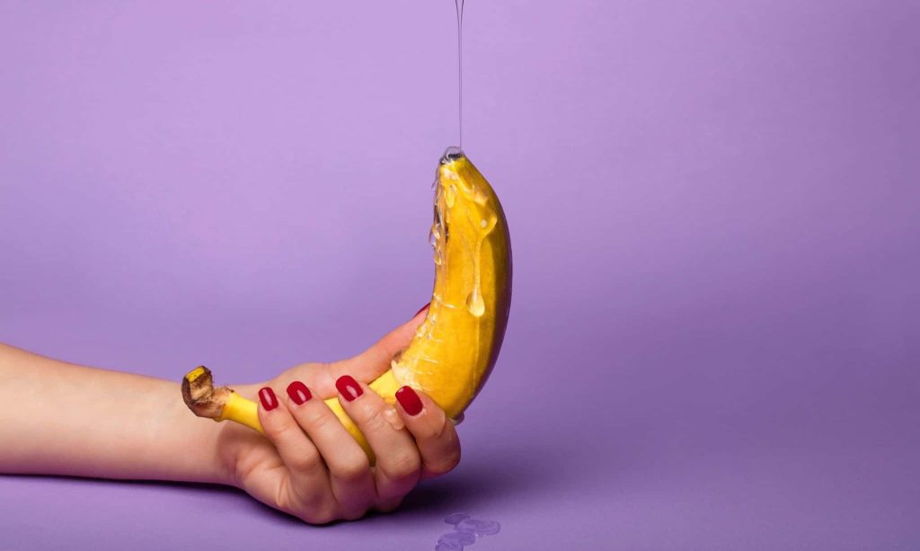 A banana being covered in honey