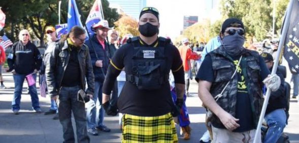 A man identified by social media sleuths as police officer Rick Fitzgerald attending a Proud Boys event