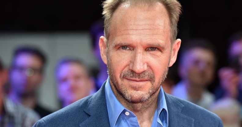 Headshot of Ralph Fiennes wearing a blue shirt and blazer