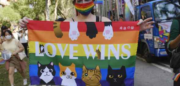 A foreign resident in Taiwan displays a rainbow flag at Taipei 2020 LGBT+ Pride