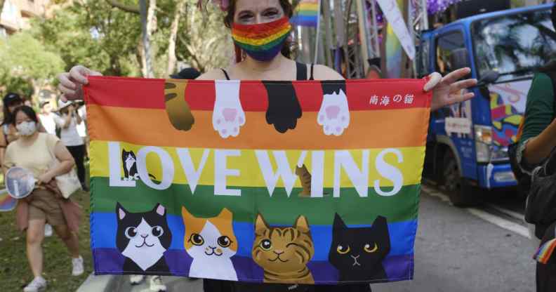A foreign resident in Taiwan displays a rainbow flag at Taipei 2020 LGBT+ Pride