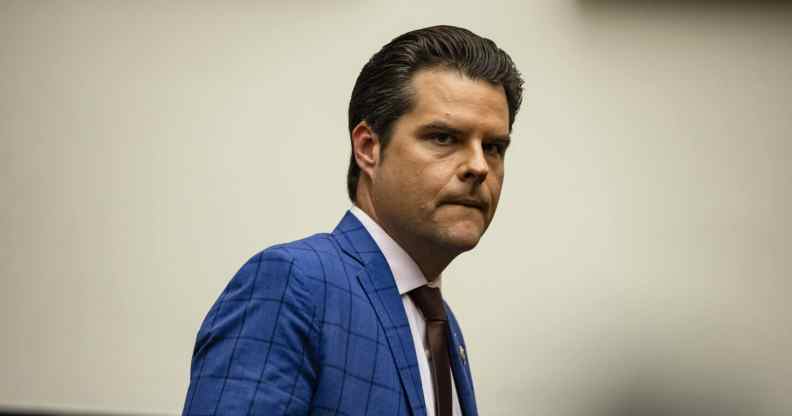 Matt Gaetz looks concerned in a blue plaid suit
