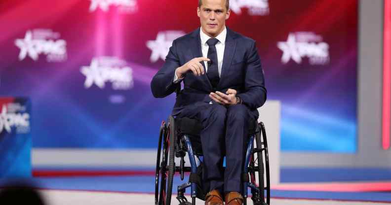 Madison Cawthorn gestures in a suit as he addresses the Conservative Political Action Conference