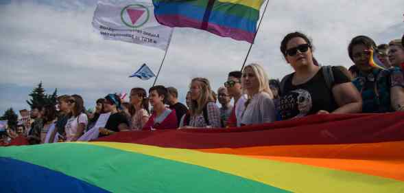 Members of the Alliance of Heterosexuals and LGBT for Equality, their flag on the left, at the St Petersburg LGBT+ Pride