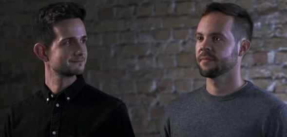 Ádám Hanol looks at Marci Pál, against a brick background