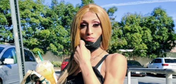 Rayanna Pardo holds a cup of Starbucks as she poses for the camera, holding her face mask down