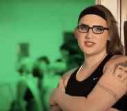 Simona Castricum leans against fridge, wearing a vest