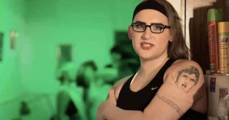 Simona Castricum leans against fridge, wearing a vest