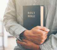 bible held in man's hands