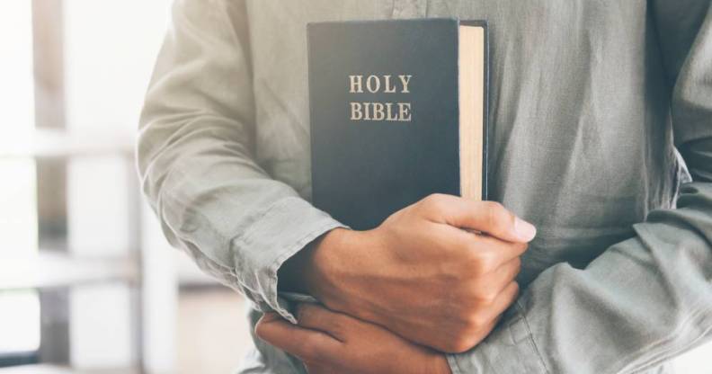 bible held in man's hands